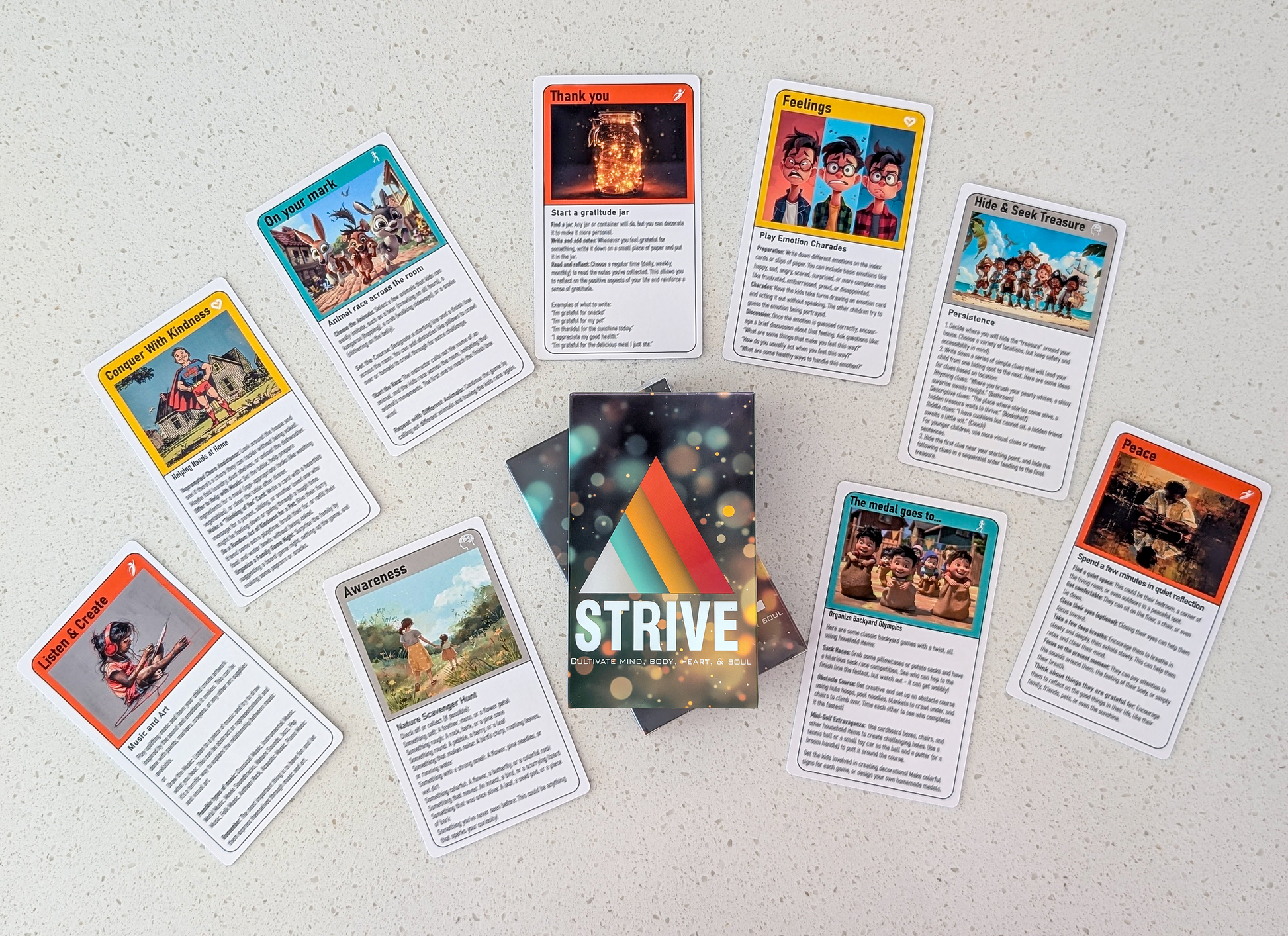 A flat lay of the activity cards for children.  Ten cards are fanned out around the deck's packaging, each featuring unique artwork and titles. Some examples include "Conquer With Kindness," "Listen & Create," and "Peace."